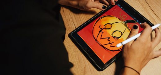 Creating a Halloween pumpkin illustration on a tablet with a stylus.